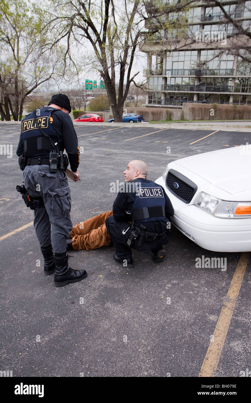 Police officers from the Tactical squad of the Street Narcotics Unit questioning suspect. Kansas City, MO, PD. Stock Photo