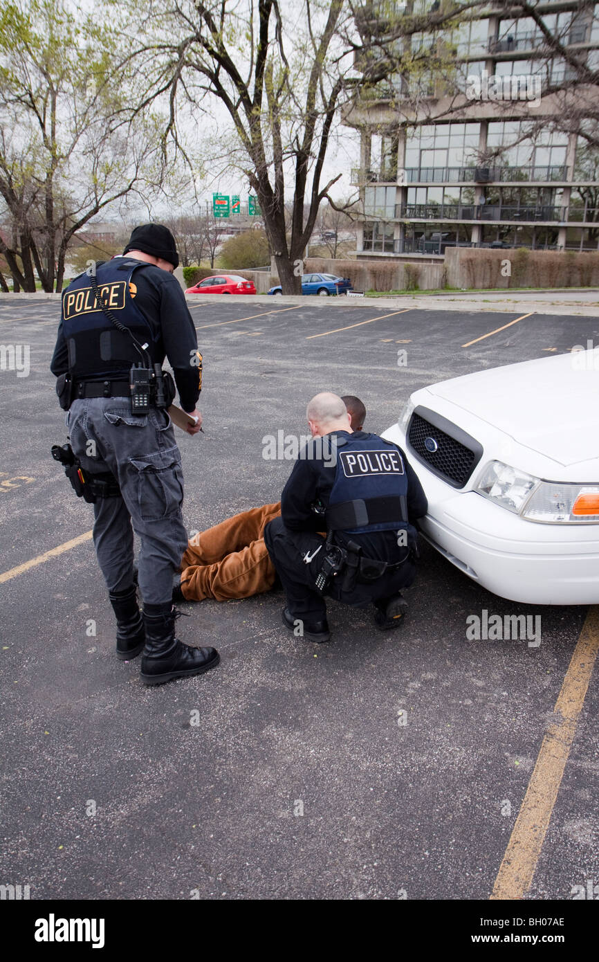 Police officers from the Tactical squad of the Street Narcotics Unit questioning suspect. Kansas City, MO, PD. Stock Photo