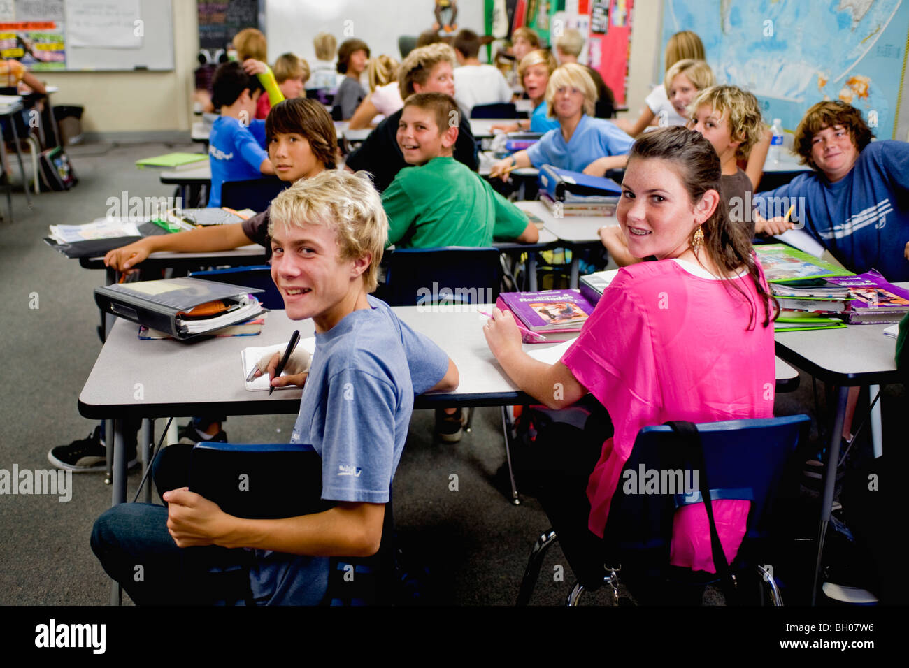 A classroom full of eight-graders greets a visitor at a Southern California middle school. Note Caucasian and Asian students Stock Photo