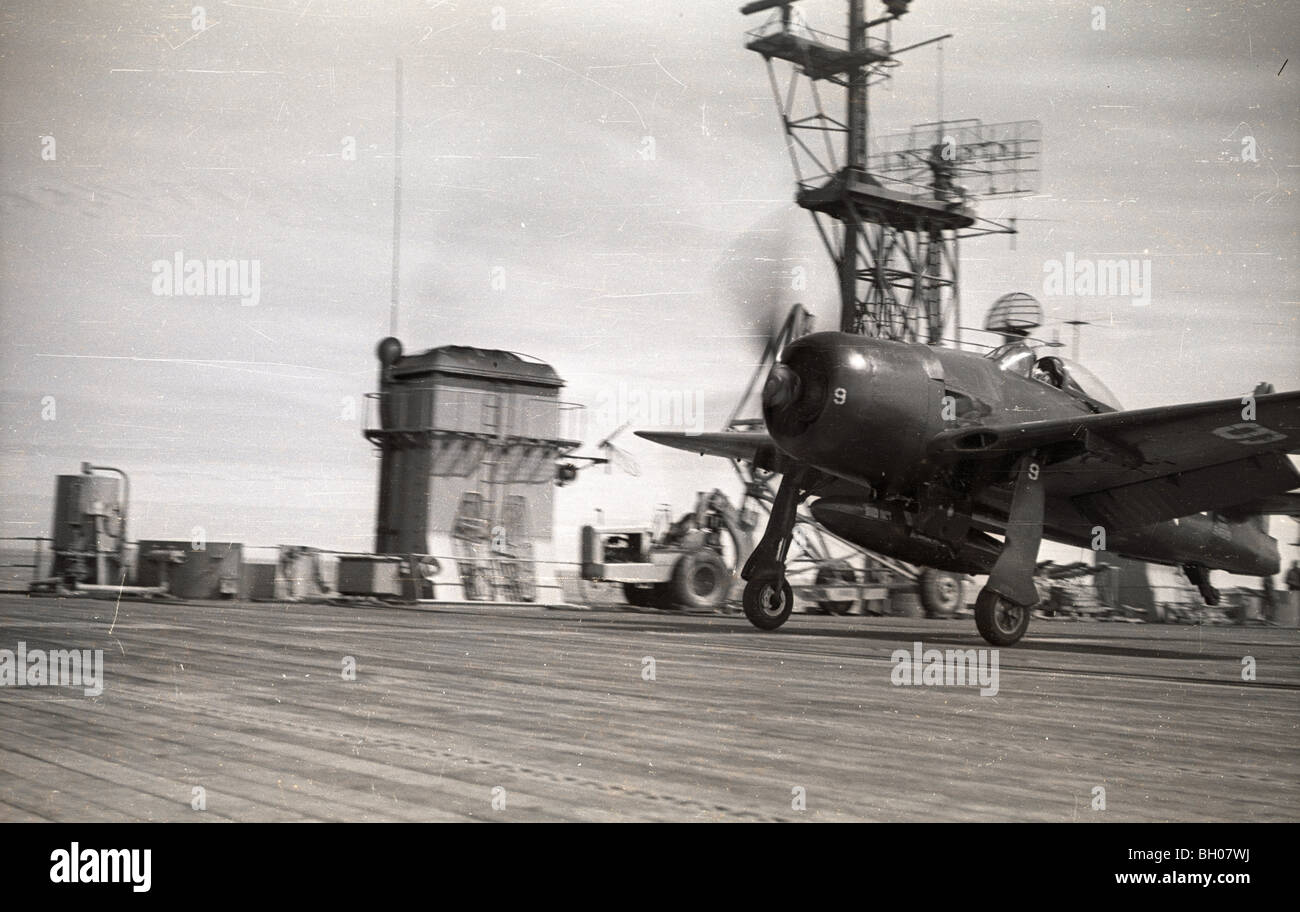 U.S. Navy Corsair airplanes fly onto and off the deck of the naval aircraft carrier Saipan during student pilot training in 1946 Stock Photo