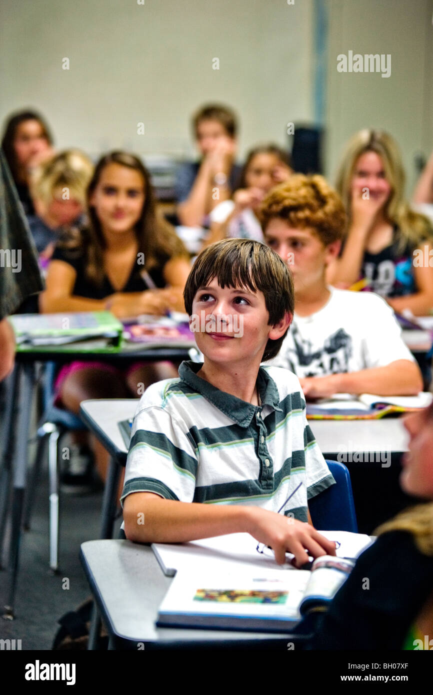 An eight-grade boy pays interested attention to his teacher at a Southern California middle school. Stock Photo