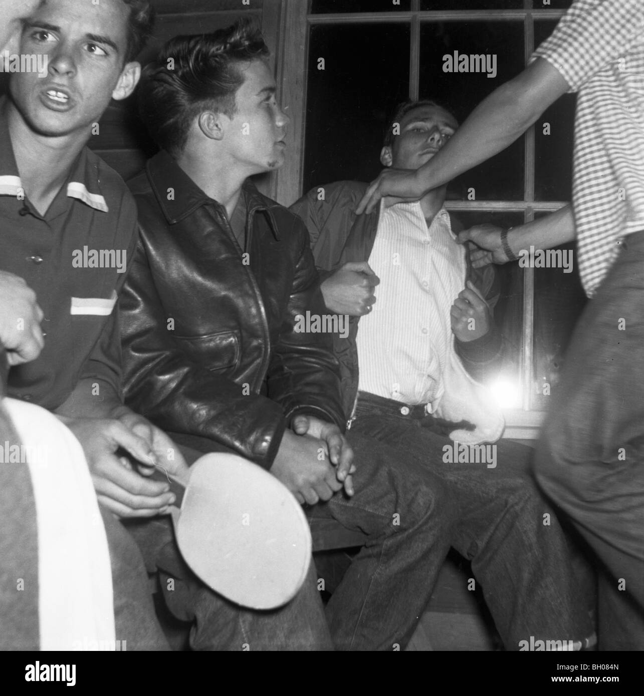 A group of young men hang out during a party in the late 1950s. Stock Photo