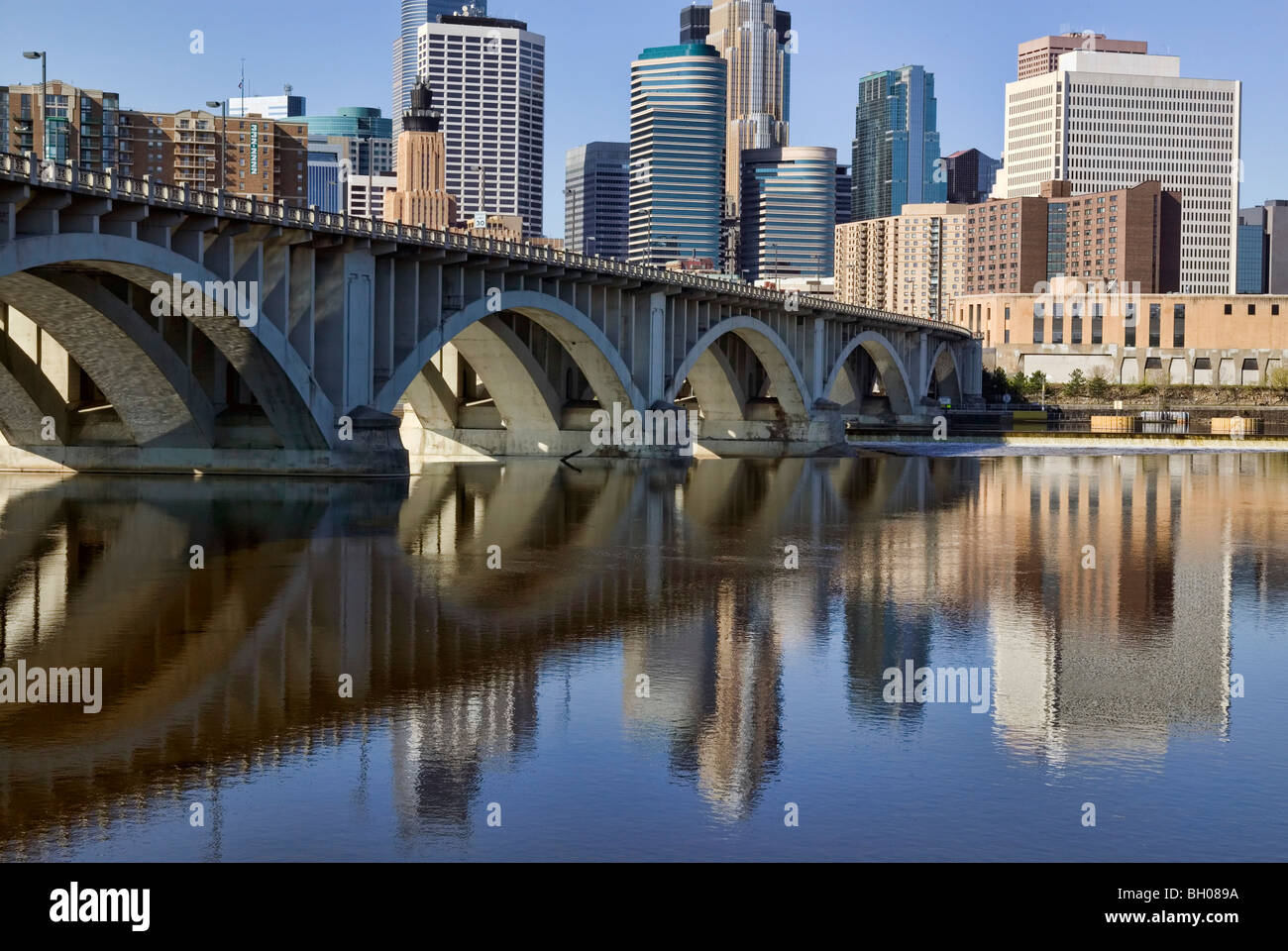 The Minneapolis ciity center and the Third Avenue Bridge reflect in the Mississippi River, Minnesota, Stock Photo