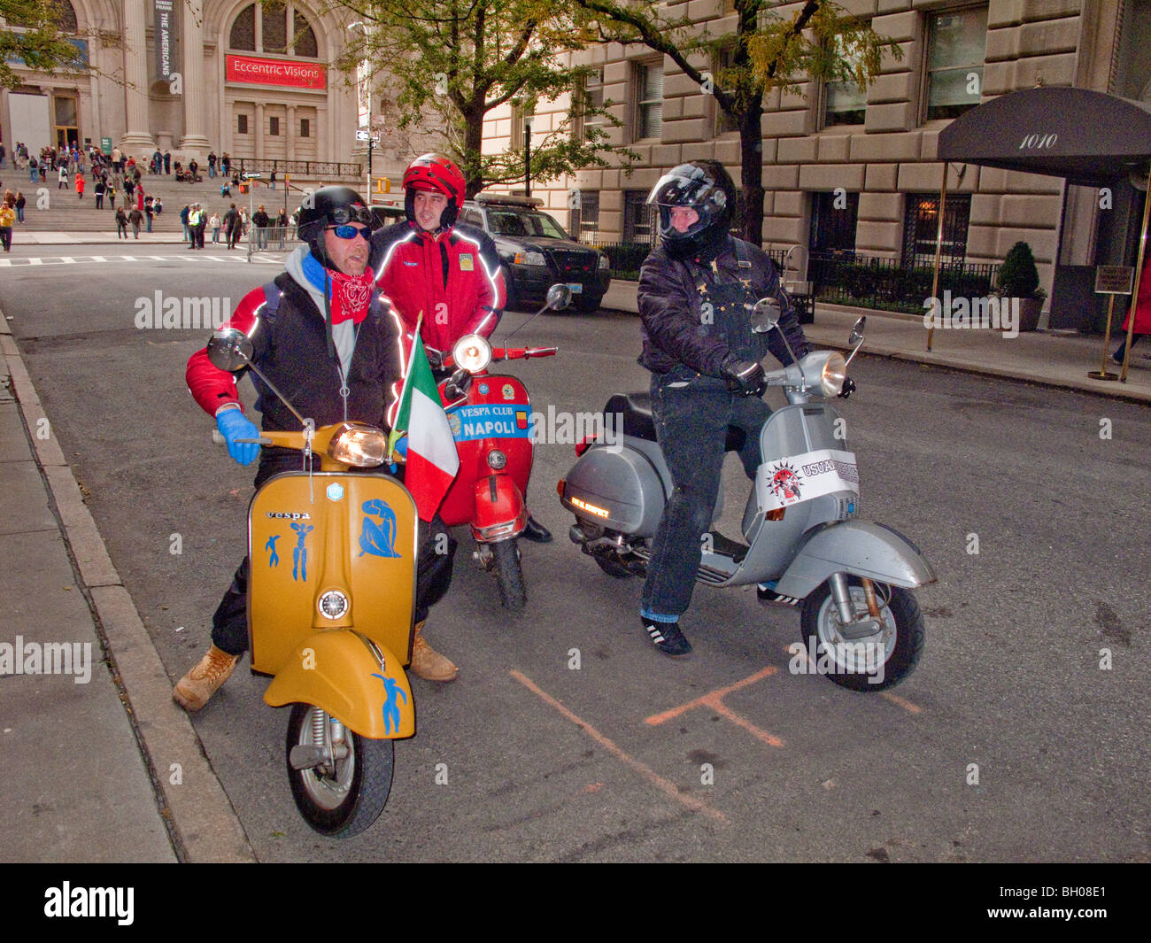 Members of a motor scooter club gather near the Metropolitan Museum of Art (background) on Fifth Avenue, New York City. Stock Photo