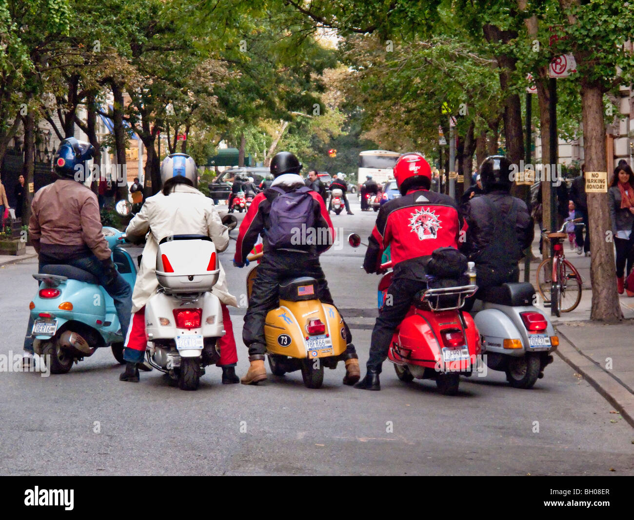 Members of a motor scooter club gather in Manhattan, New York City. Note helmets. Stock Photo