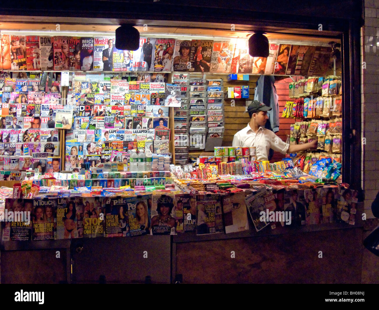 A newsstand in a New York City subway station offers both snacks and current periodicals for the convenience of urban travelers. Stock Photo
