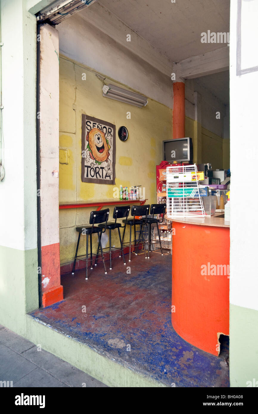 simple cheerful colorful small torta sandwich shop with an eating counter open to the street in Oaxaca City Oaxaca State Mexico Stock Photo