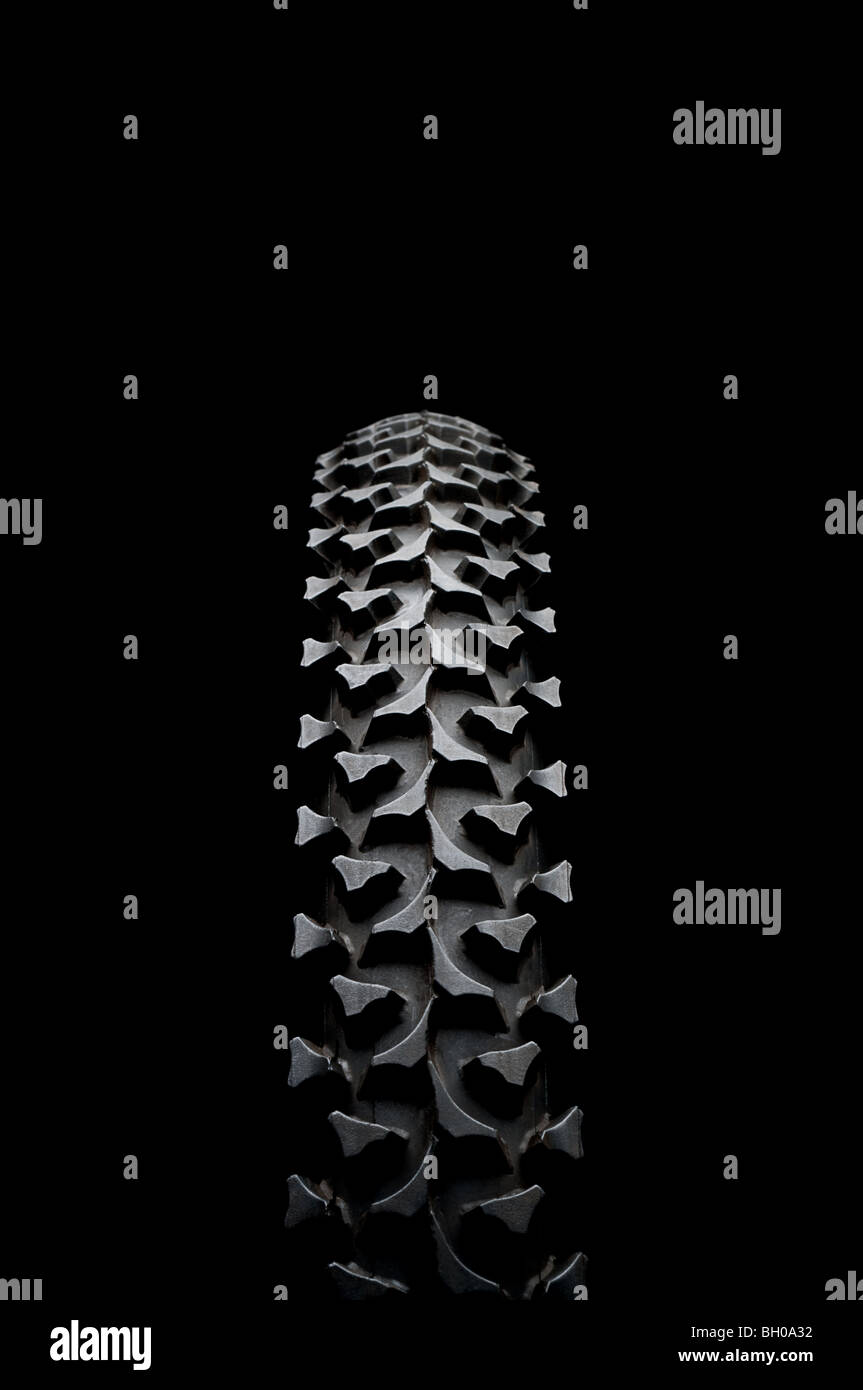 Vertical close up of a mountain bike tire on black Stock Photo