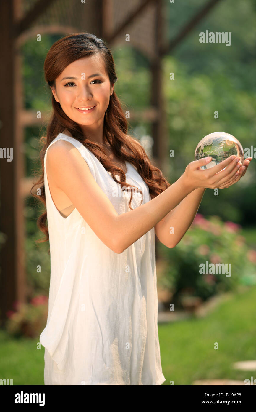 young woman holding crystal ball Stock Photo - Alamy