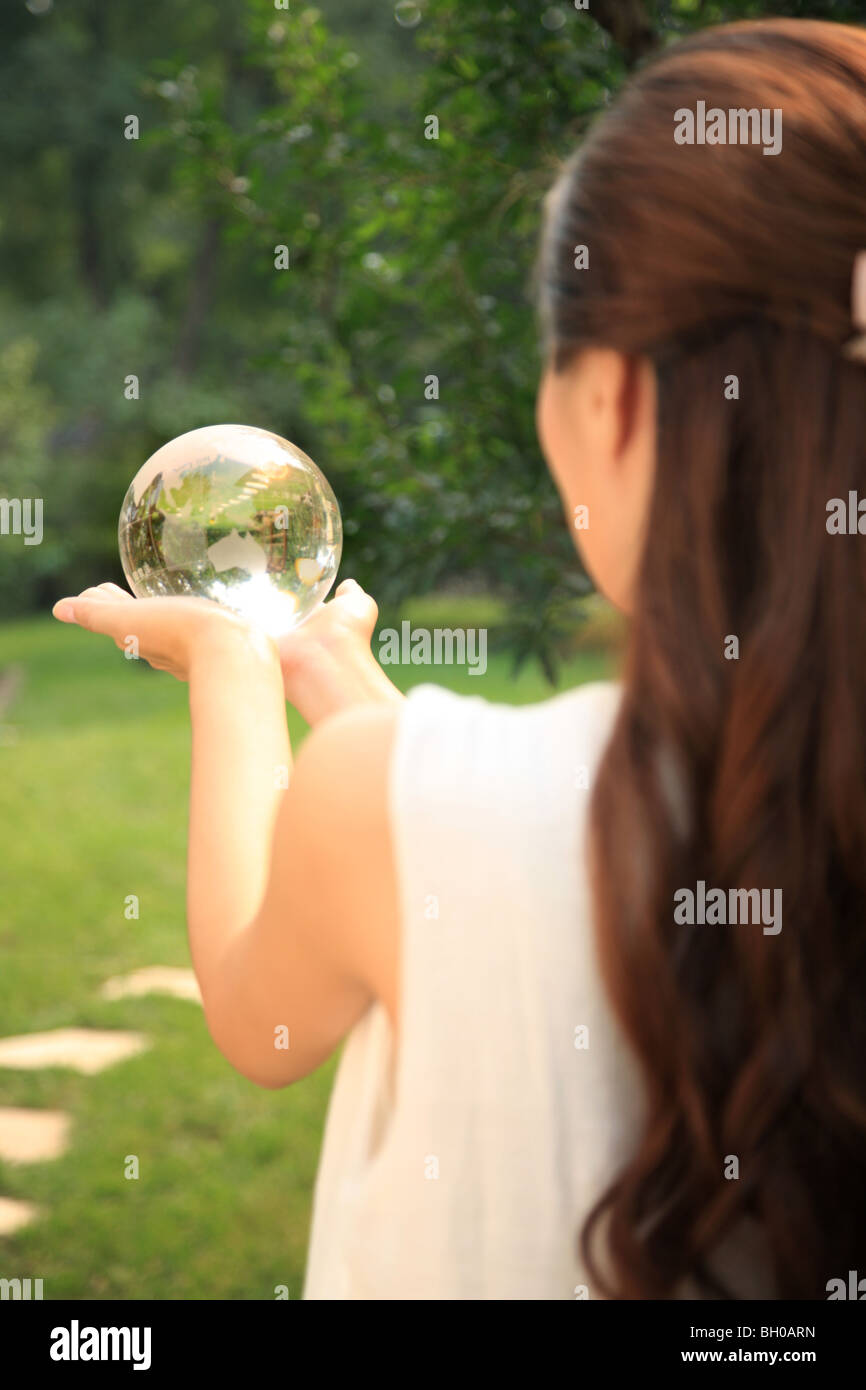 young woman holding crystal ball Stock Photo - Alamy