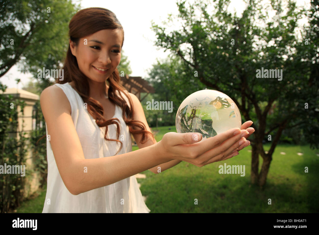 young woman holding crystal ball Stock Photo - Alamy
