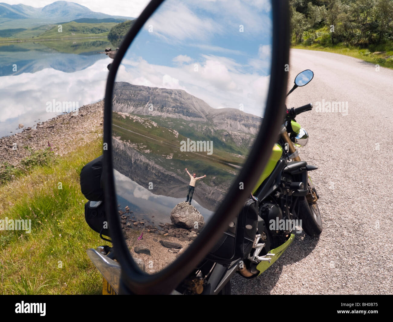 Scotland, UK, Europe. Man and landscape reflected in a motorbike wing mirror Stock Photo