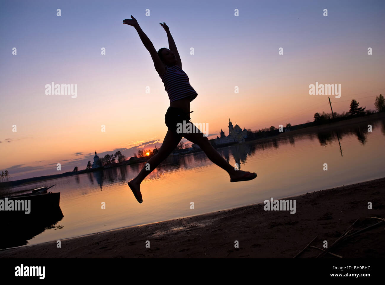 Silhouette of a young jumping girl Stock Photo