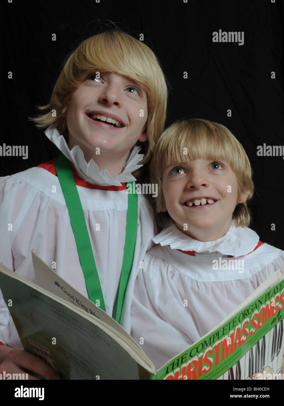 Two angelic choirboys singing Christmas carols Stock Photo