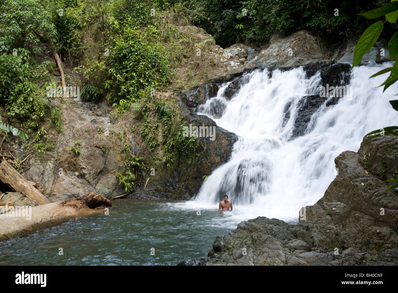 Young man bathing by waterfall. Embera Indian Village. Chagres National ...