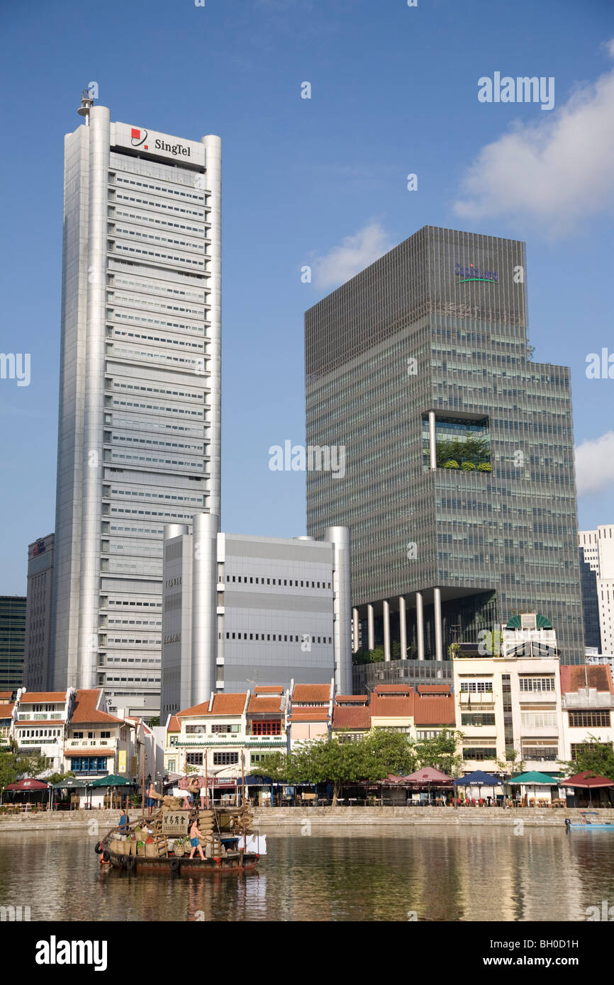Singapore. City skyscrapers towering over old waterfront houses at Boat Quay. Stock Photo