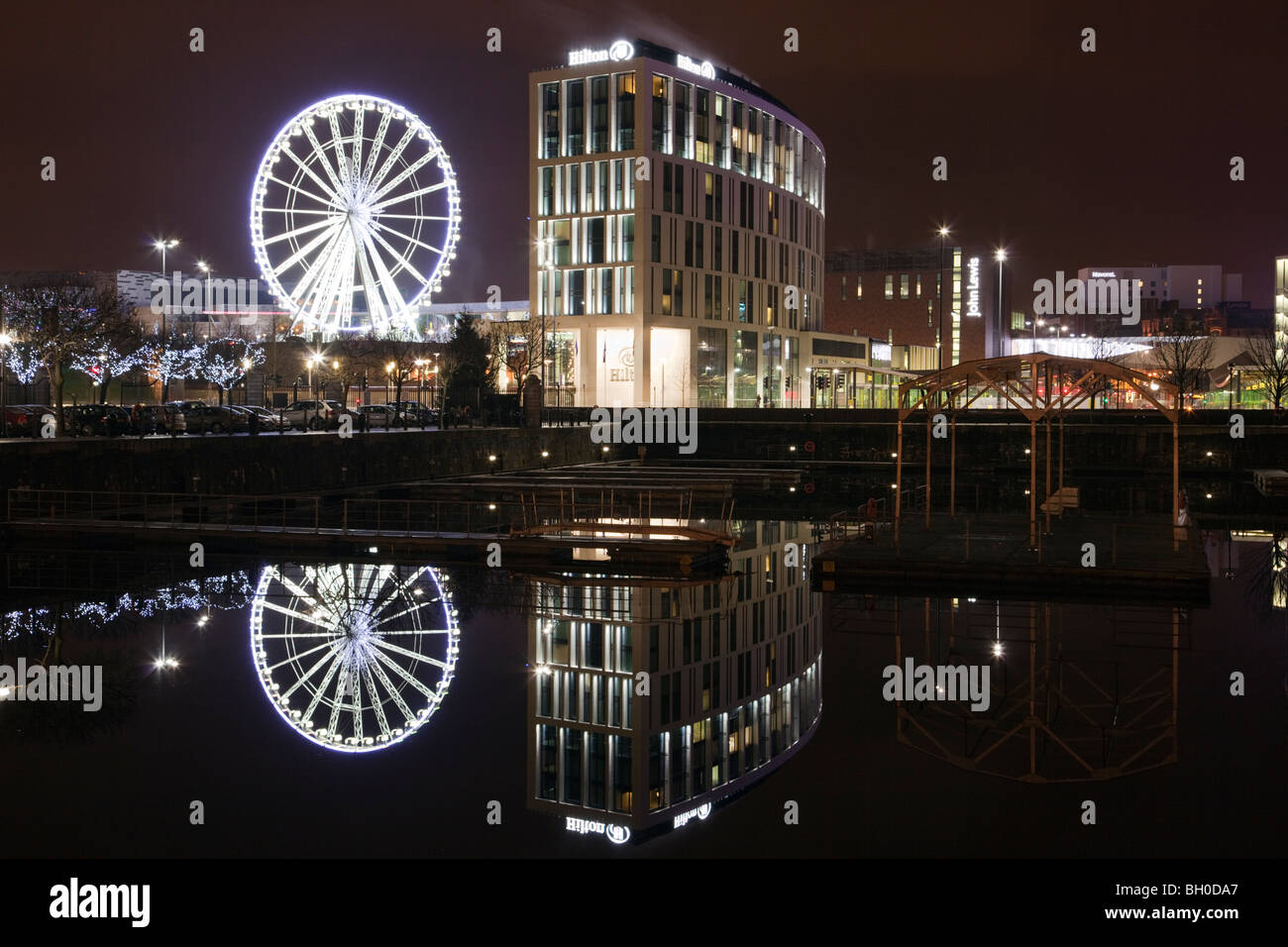 Liverpool, Merseyside, England, UK, Britain. Liverpool One Wheel and waterfront reflections in Salthouse Dock at night Stock Photo