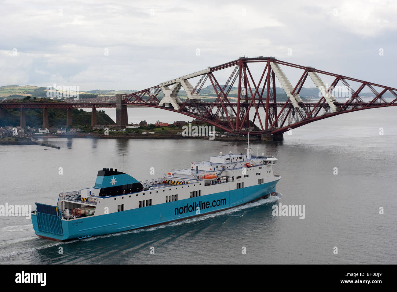 A Norfolkline vessel passing under the Forth Railway Bridge at Queensferry, Scotland Stock Photo