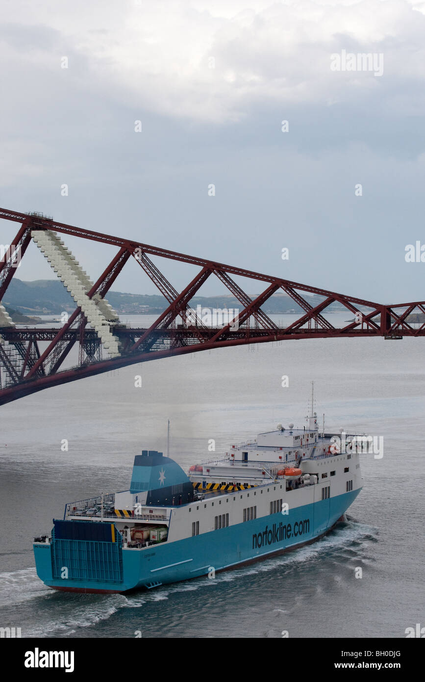 A Norfolkline vessel passing under the Forth Railway Bridge at Queensferry, Scotland Stock Photo