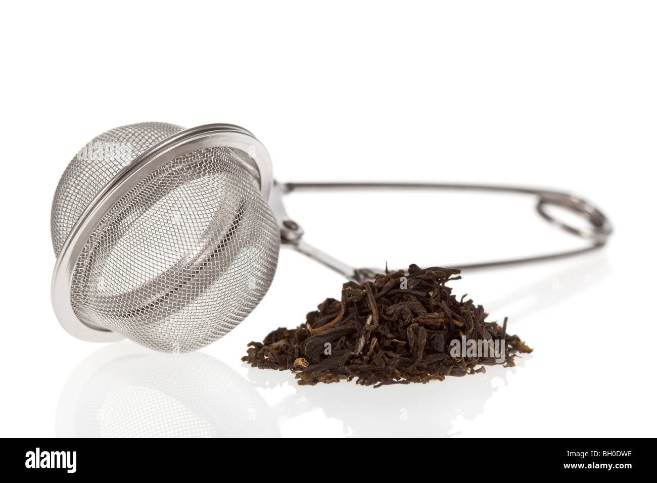 Tea infuser with Green Tea leaves isolated on a white background Stock Photo