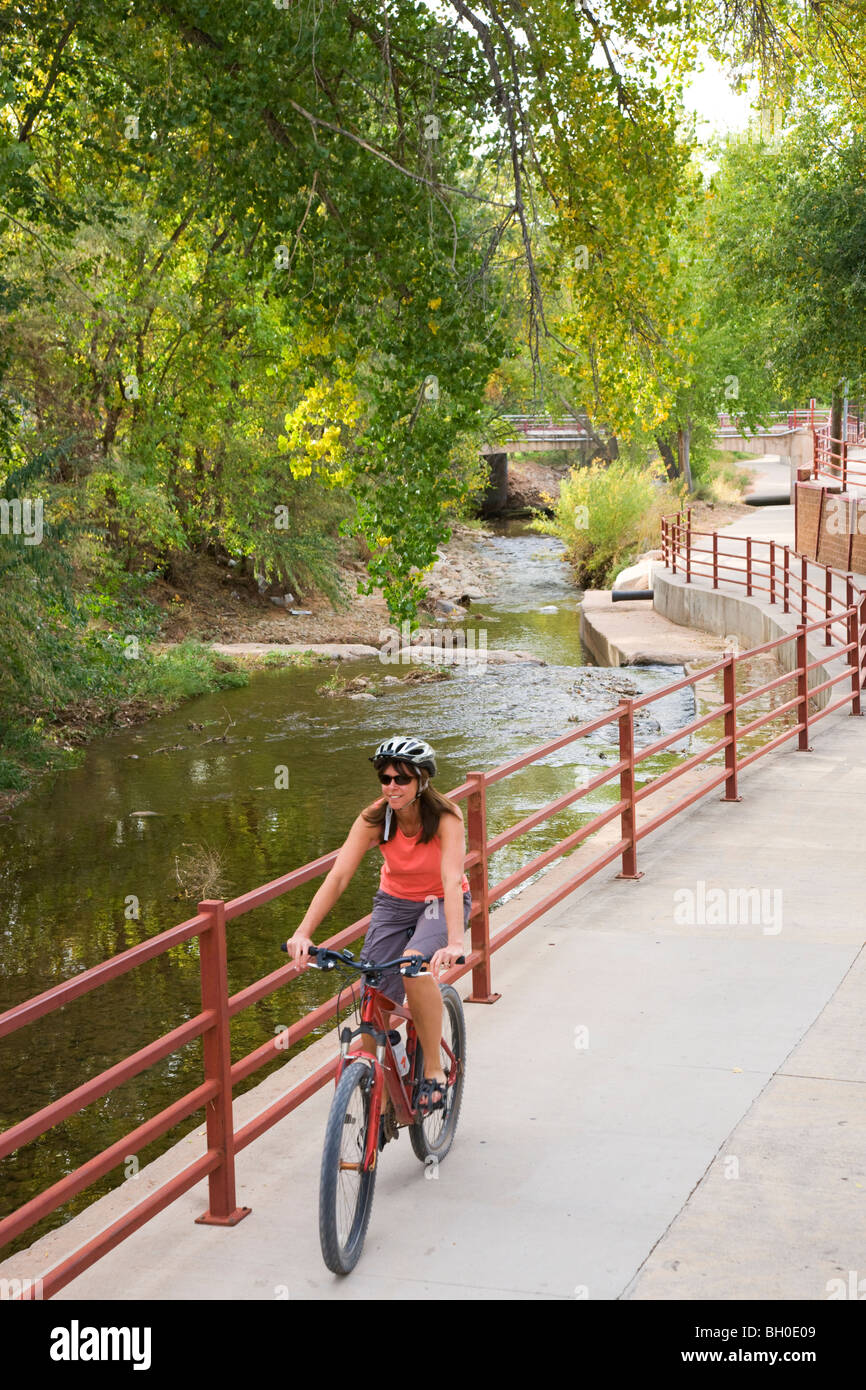 A visitor rides on a bike trail through downtown Moab, Utah. (model released) Stock Photo