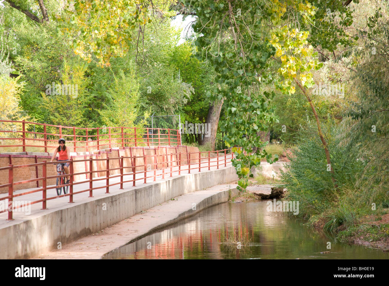 A visitor rides on a bike trail through downtown Moab, Utah. (model