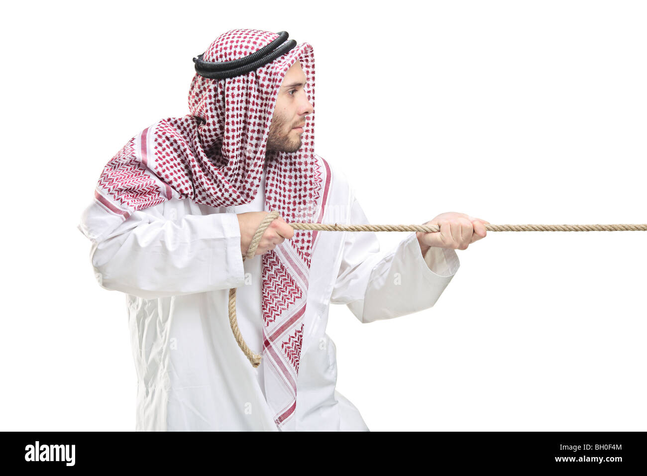 Arab person pulling a rope,isolated on white background Stock Photo