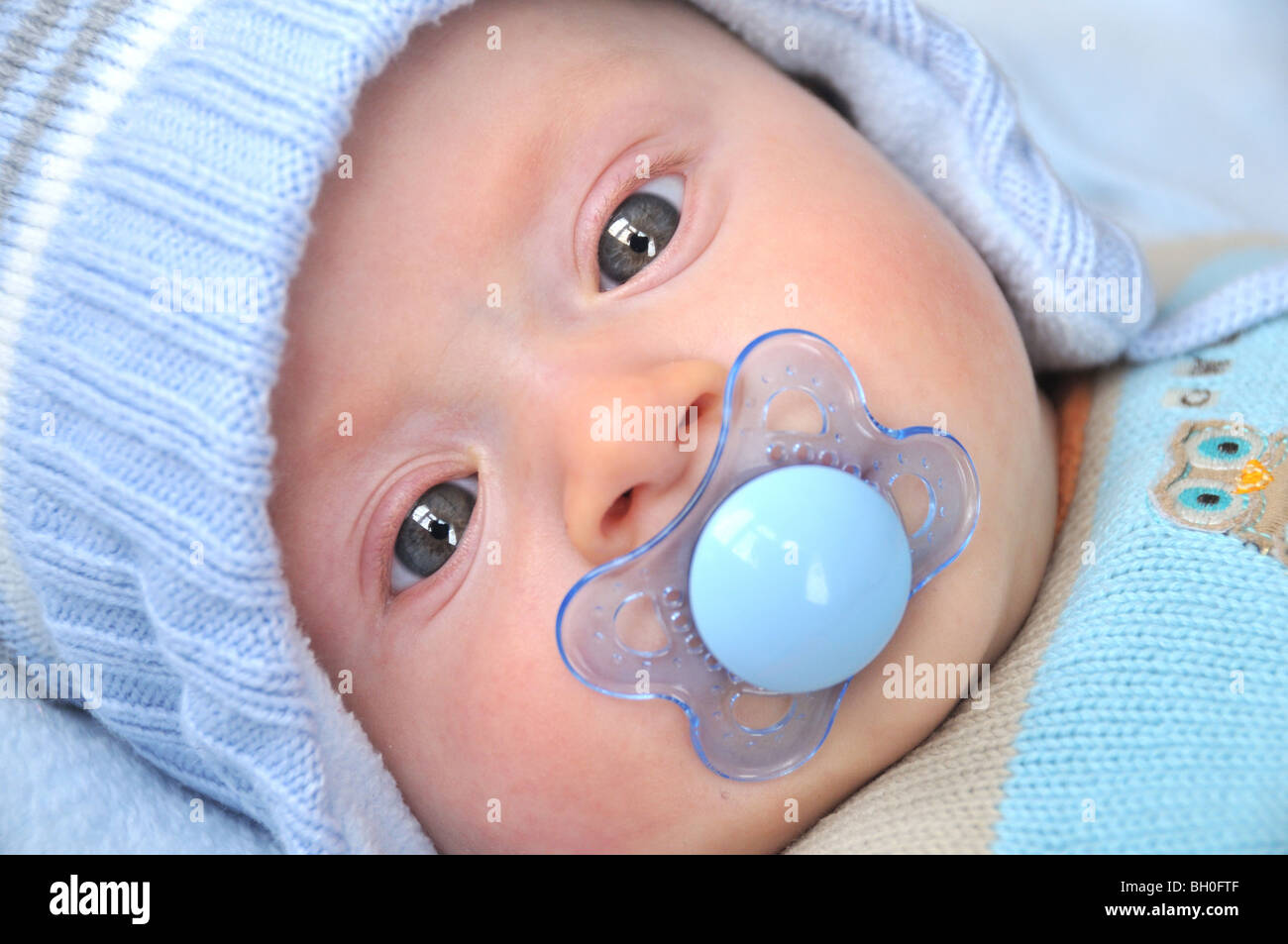 Baby with a dummy Stock Photo - Alamy