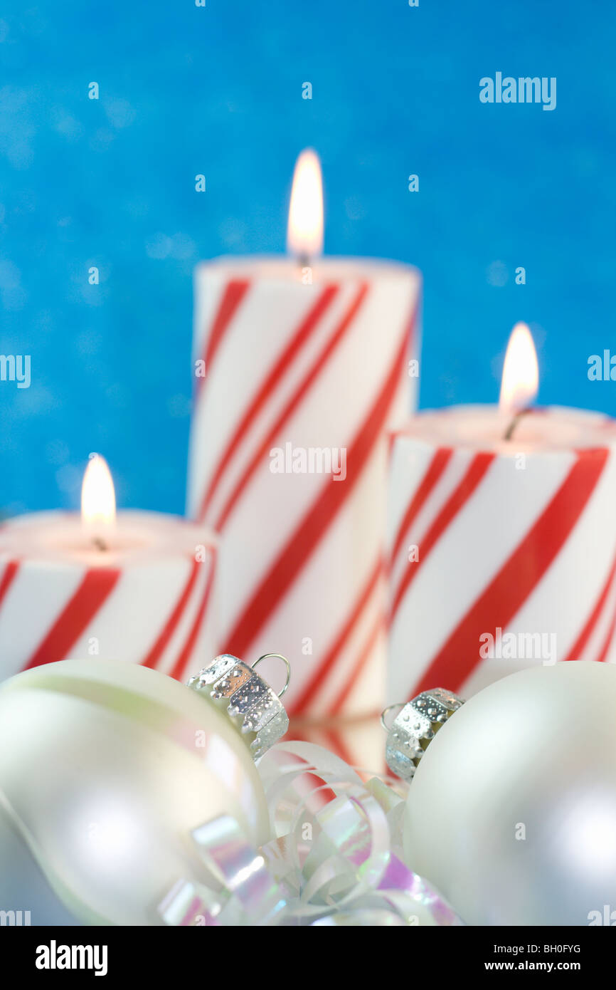 two pearl white ornaments with Christmas candle background Stock Photo