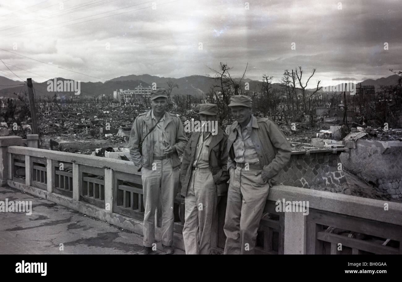 Americans posing for a photo. Scene from Hiroshima, Japan in ruins shortly after the Atomic Bomb was dropped Stock Photo