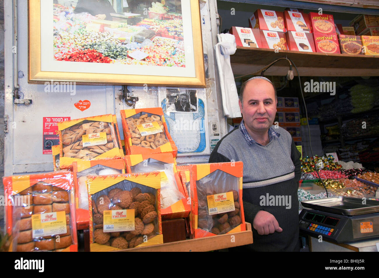 Israel, Jerusalem, Machane Yehuda market Seller at his stall Stock Photo