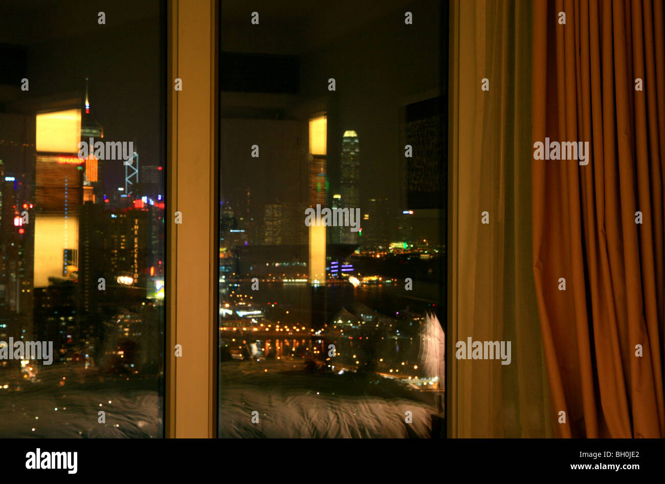 Curtain At The Window Of A Hotel Room View At The City At Night