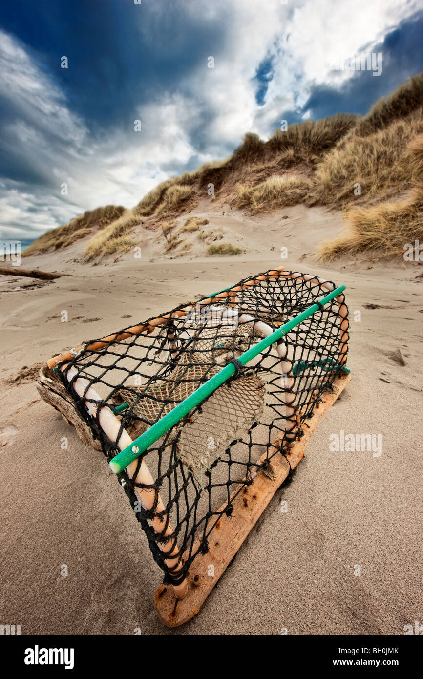 Lobster pot on a Northumbrian beach on a stormy winter's day Stock Photo