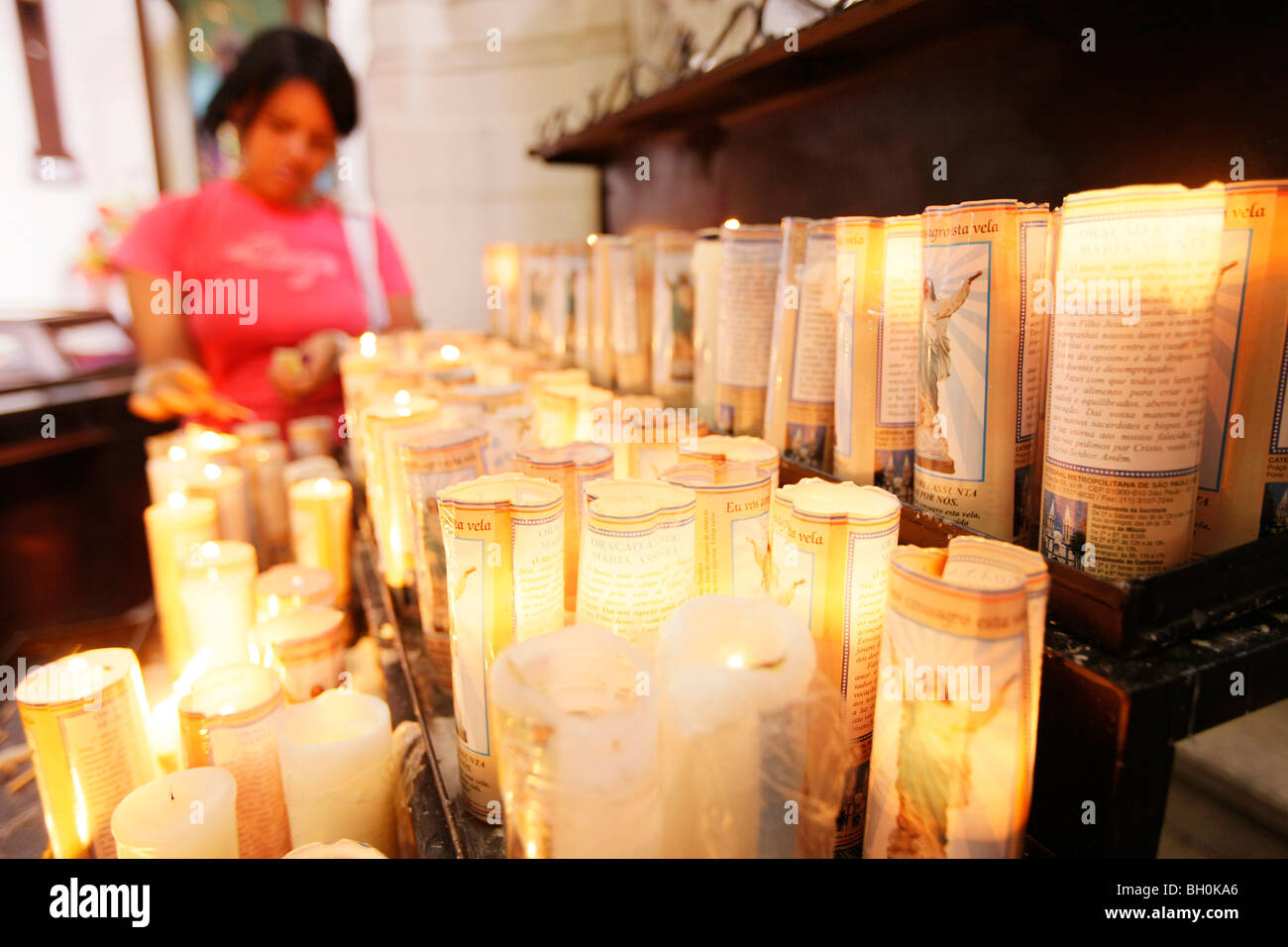 Believer lightening a candle, Kathedrale Metropolitana da Sé, Sao Paulo, Brazil Stock Photo