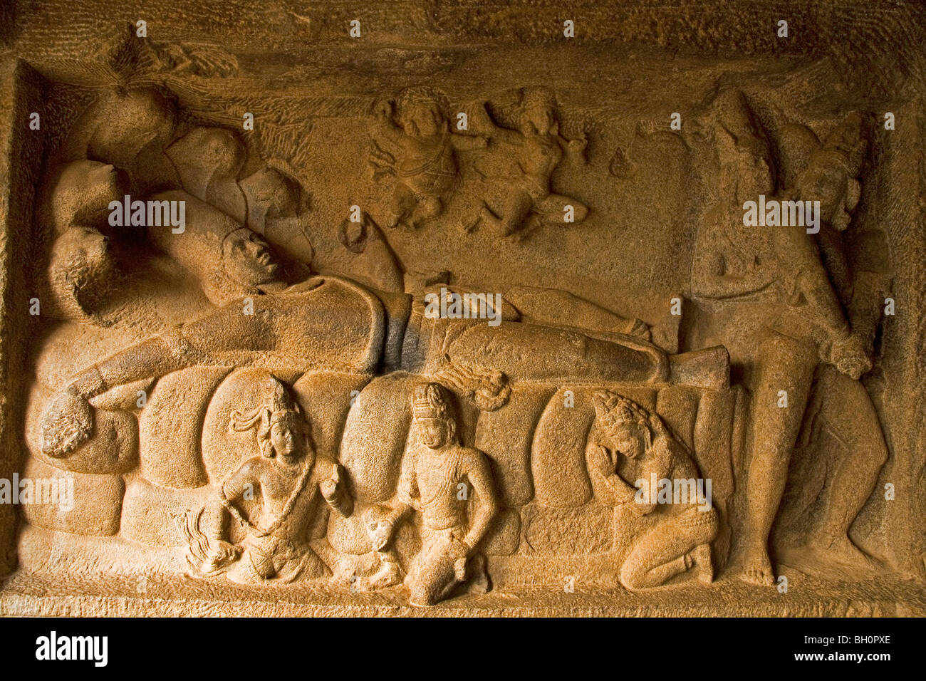 A bas relief sculpture in the Indian city of Mahabalipuram (Mamallapuram) shows Vishnu reclining in meditation. Stock Photo