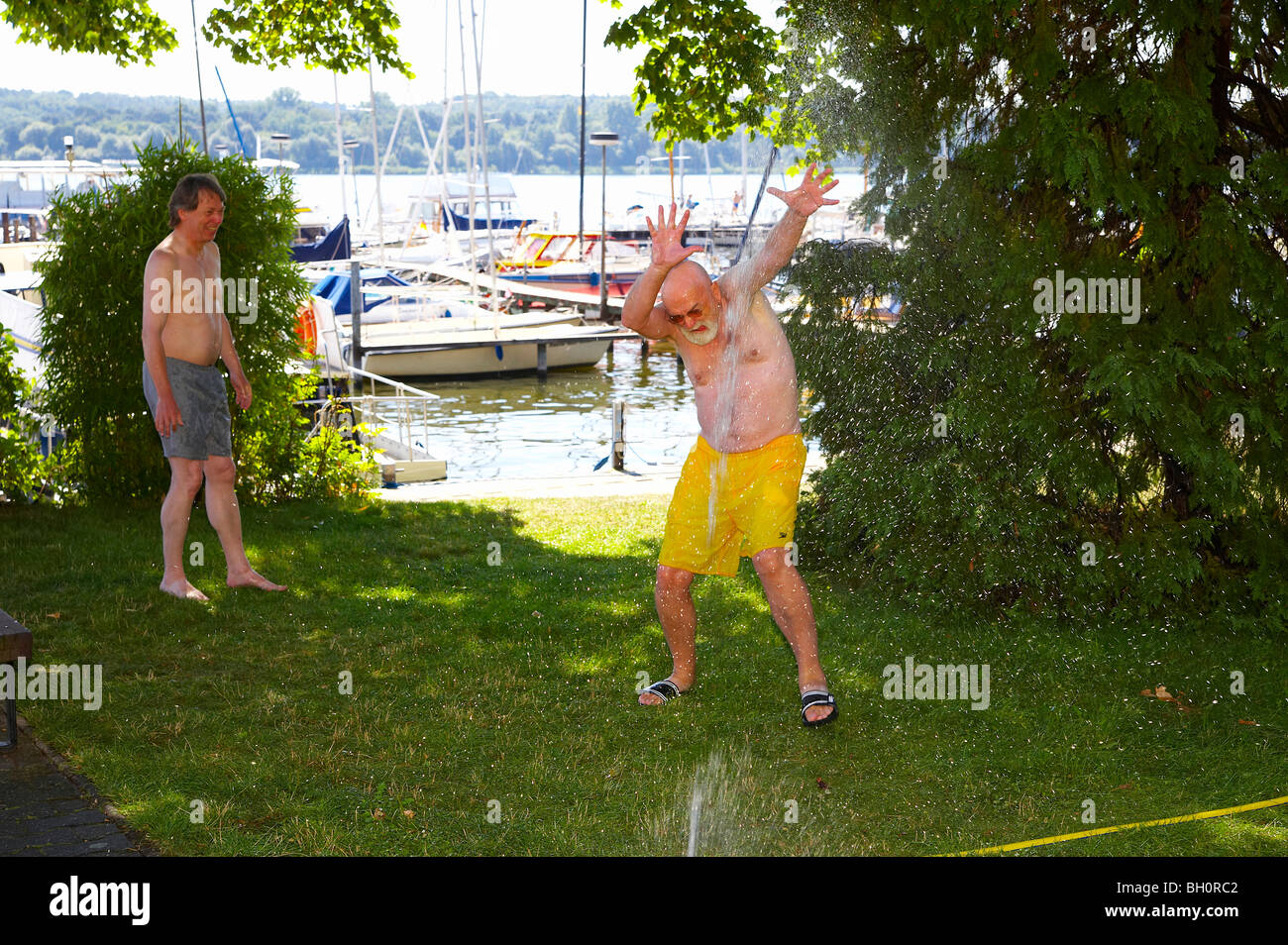 cooling down under a hose, Wannsee, river Havel, Brandenburg, Germany, Europe Stock Photo