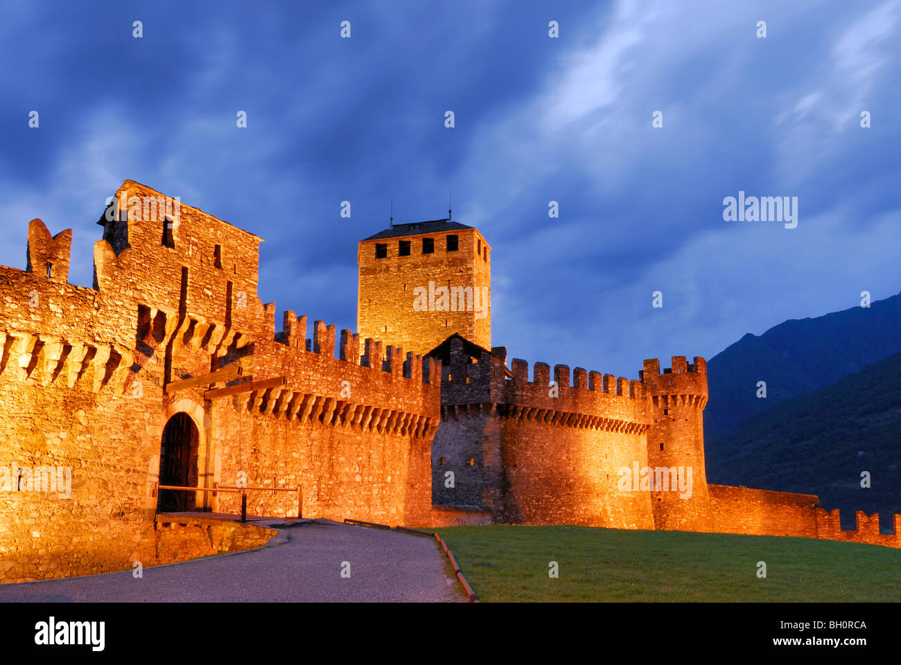 Illuminated castle Castello di Montebello with draw bridge in UNESCO