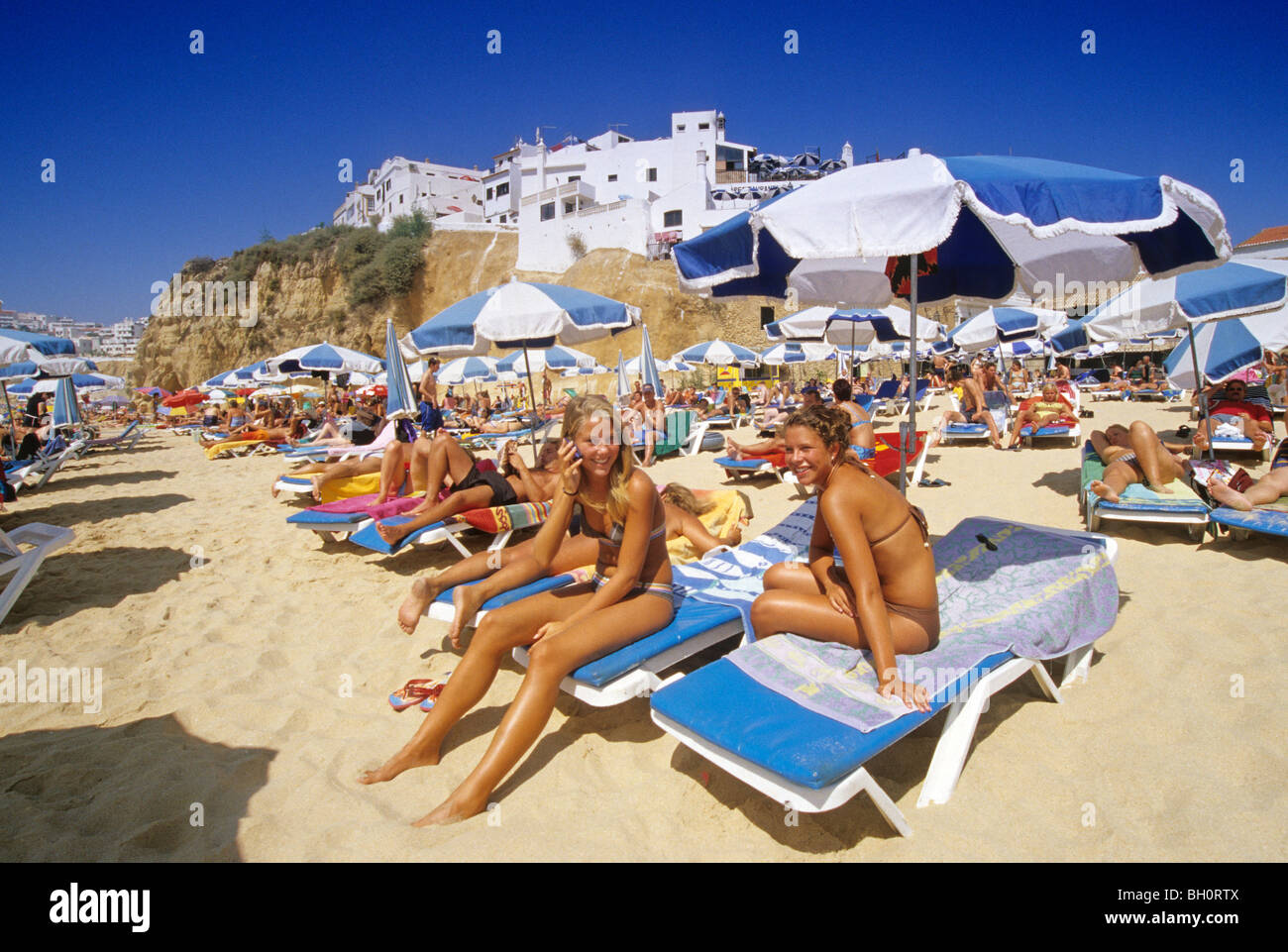 telephoning-girl-people-on-the-beach-under-blue-sky-albufeira-algarve-BH0RTX.jpg