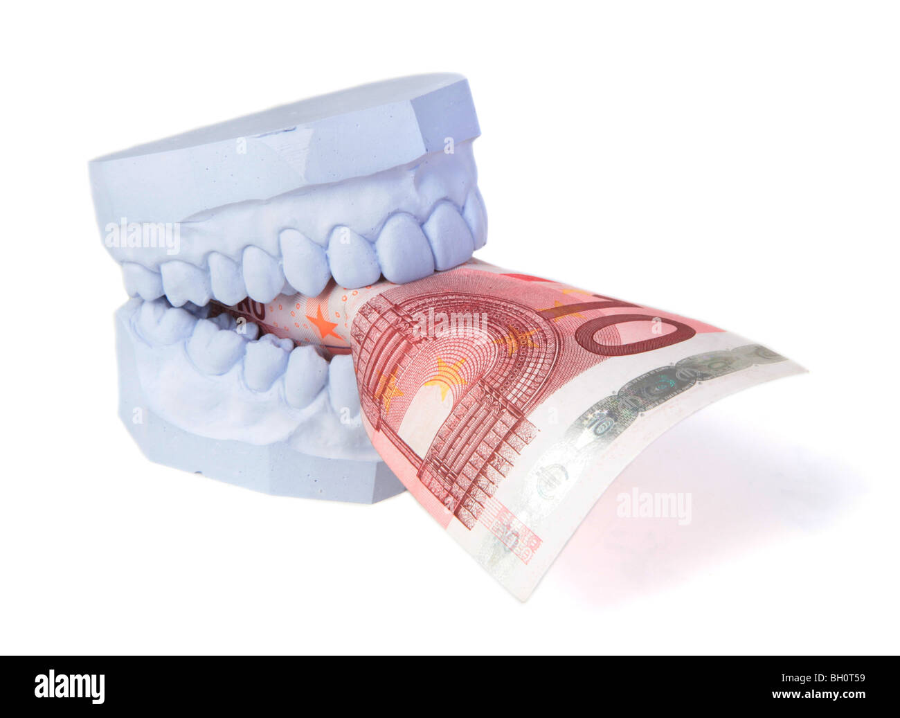 A set of teeth with some money. All isolated on white background. Stock Photo