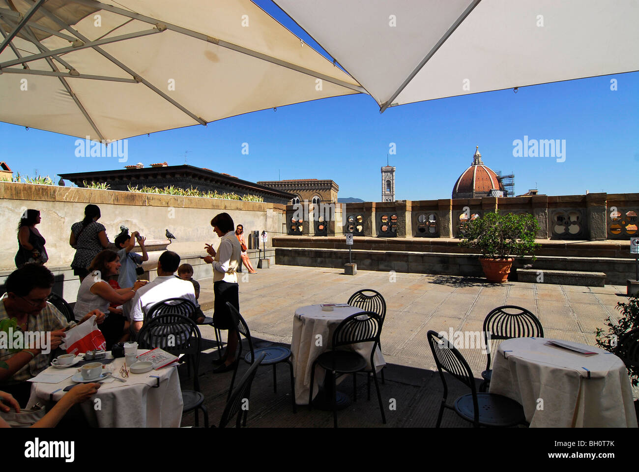 People sitting on the roof terrace of the Uffizi gallery under sunshades, Florence, Tuscany, Italy, Europe Stock Photo