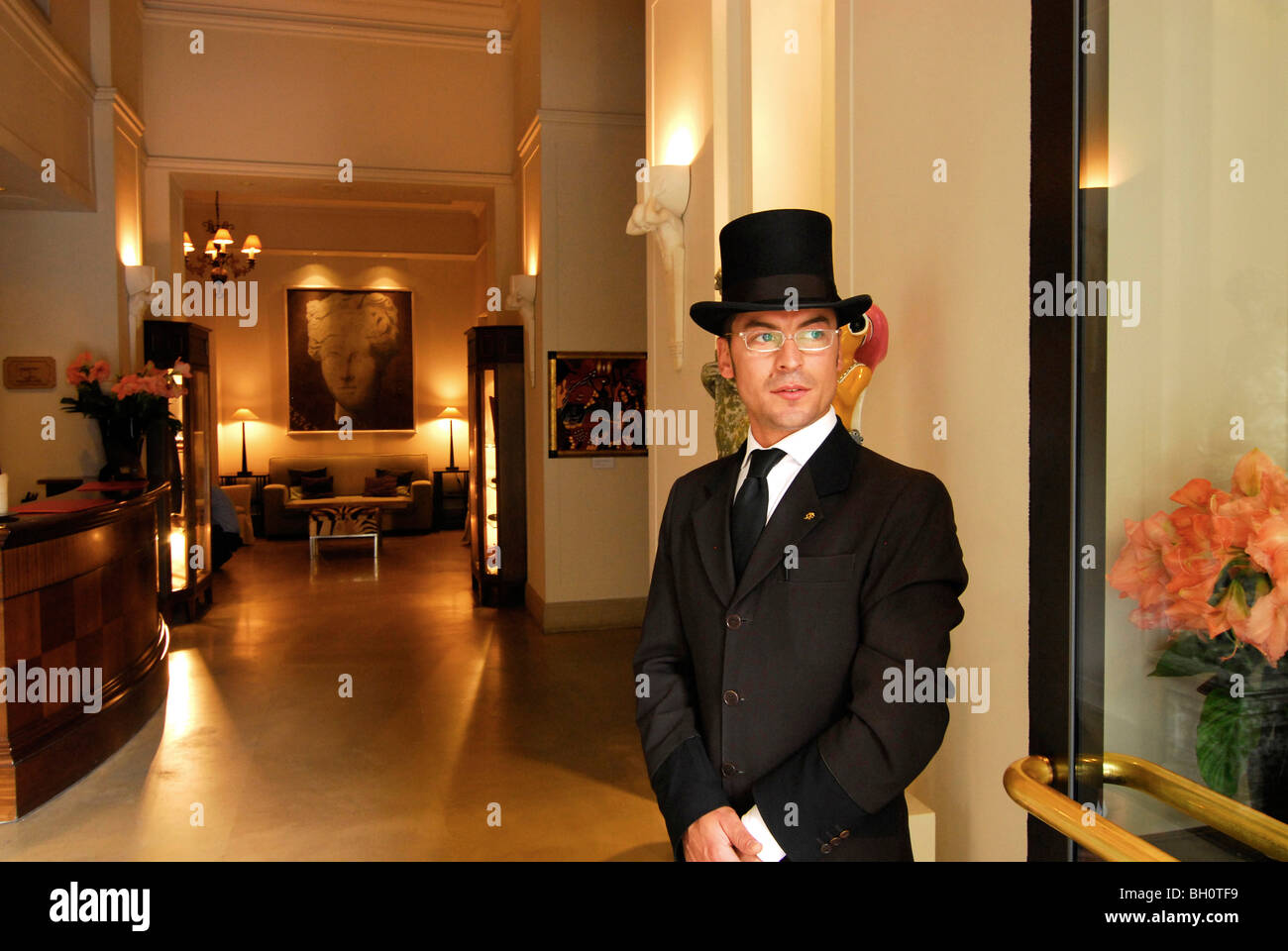 Doorman wearing a top hat in front of the lobby of the Savoy Hotel, Florence, Tuscany, Italy, Europe Stock Photo