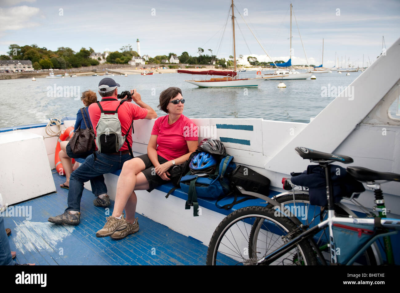 Foot passengers take the small foot ferry across the River Odet between Benodet and Sainte Marine in Brittany, France Stock Photo