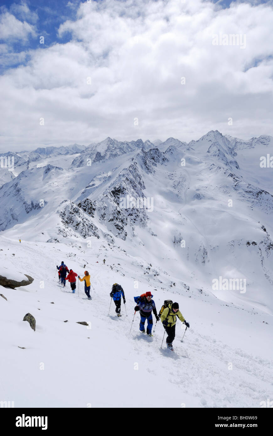 Group of backcountry skiers ascending and descending summit of Lamsenspitze, Sellrain, Stubai range, Tyrol, Austria Stock Photo