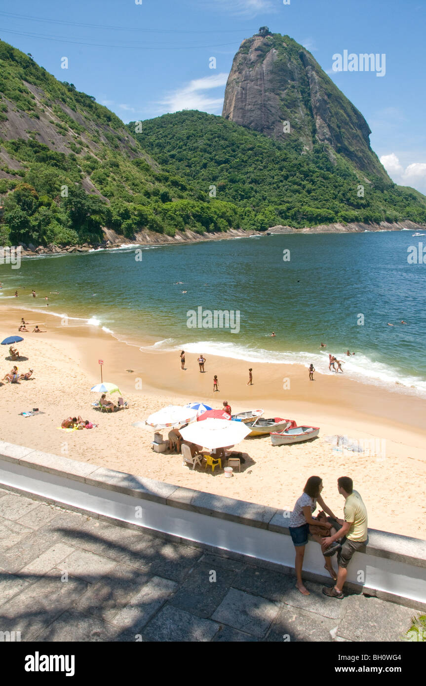 Brazil. sunbathers at Praia Vermelha,Urca, in Rio de Janeiro, with Sugar Loaf mountain in background Stock Photo