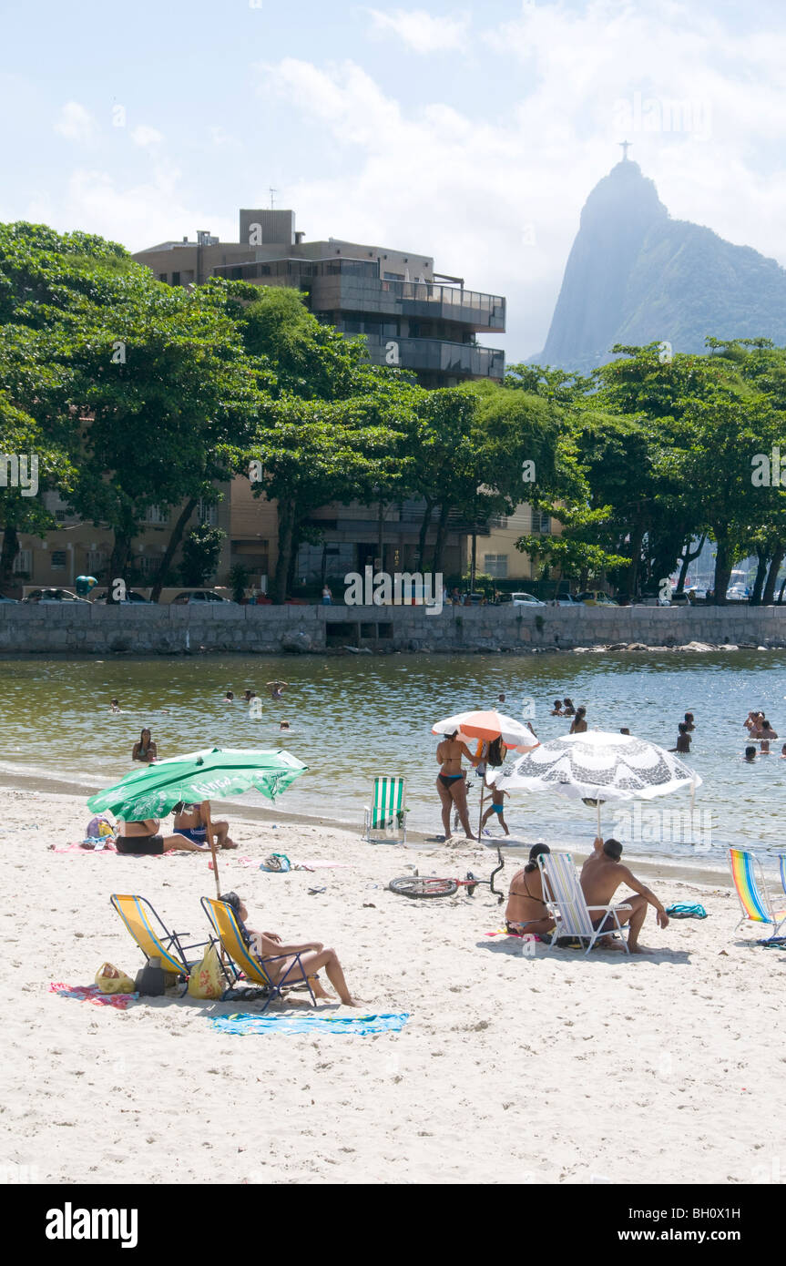 Brazil. sunbathers at Urca beach, in Rio de Janeiro, with Corcovado