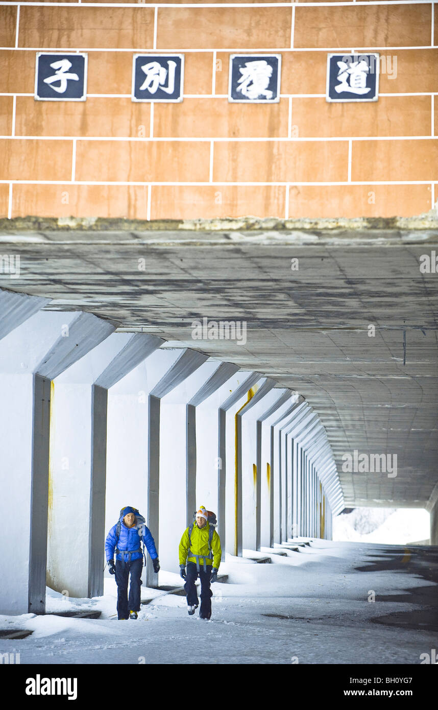 Two men walking through a pedestrian underpass in winter, Hokkaido 