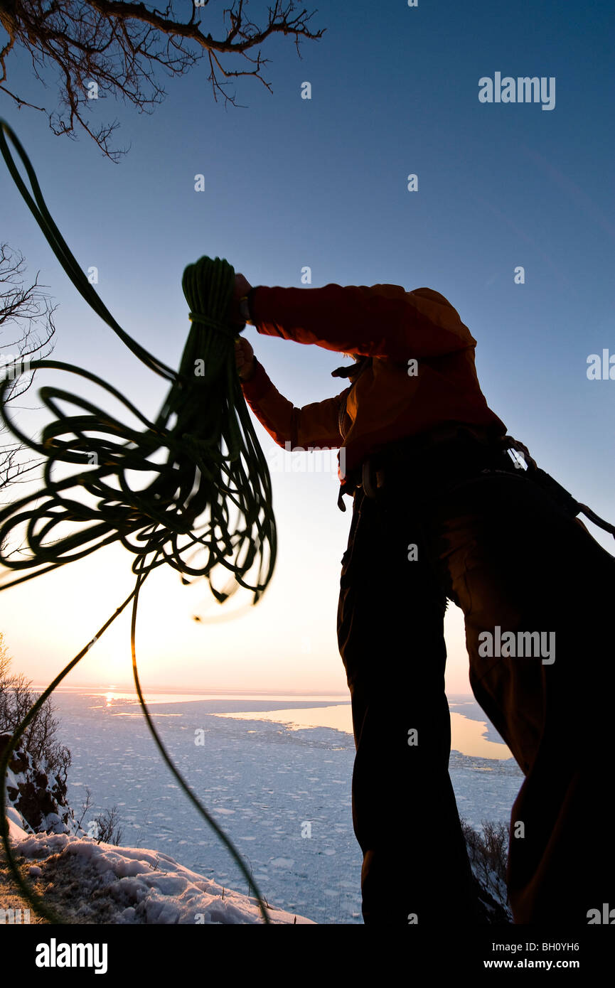 A man throwing a climbing rope at sunset, Hokkaido, Japan, Asia Stock Photo