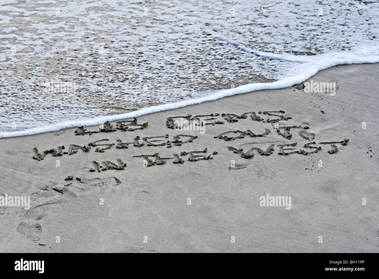 Liberal Democrats all washed up written in sand with a rising tide. symbolic. Stock Photo