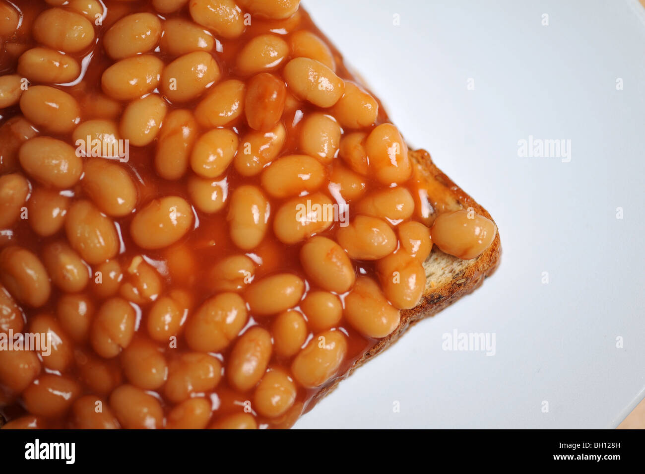 A British favourite lunch time meal, a plate of beans on toast. Stock Photo