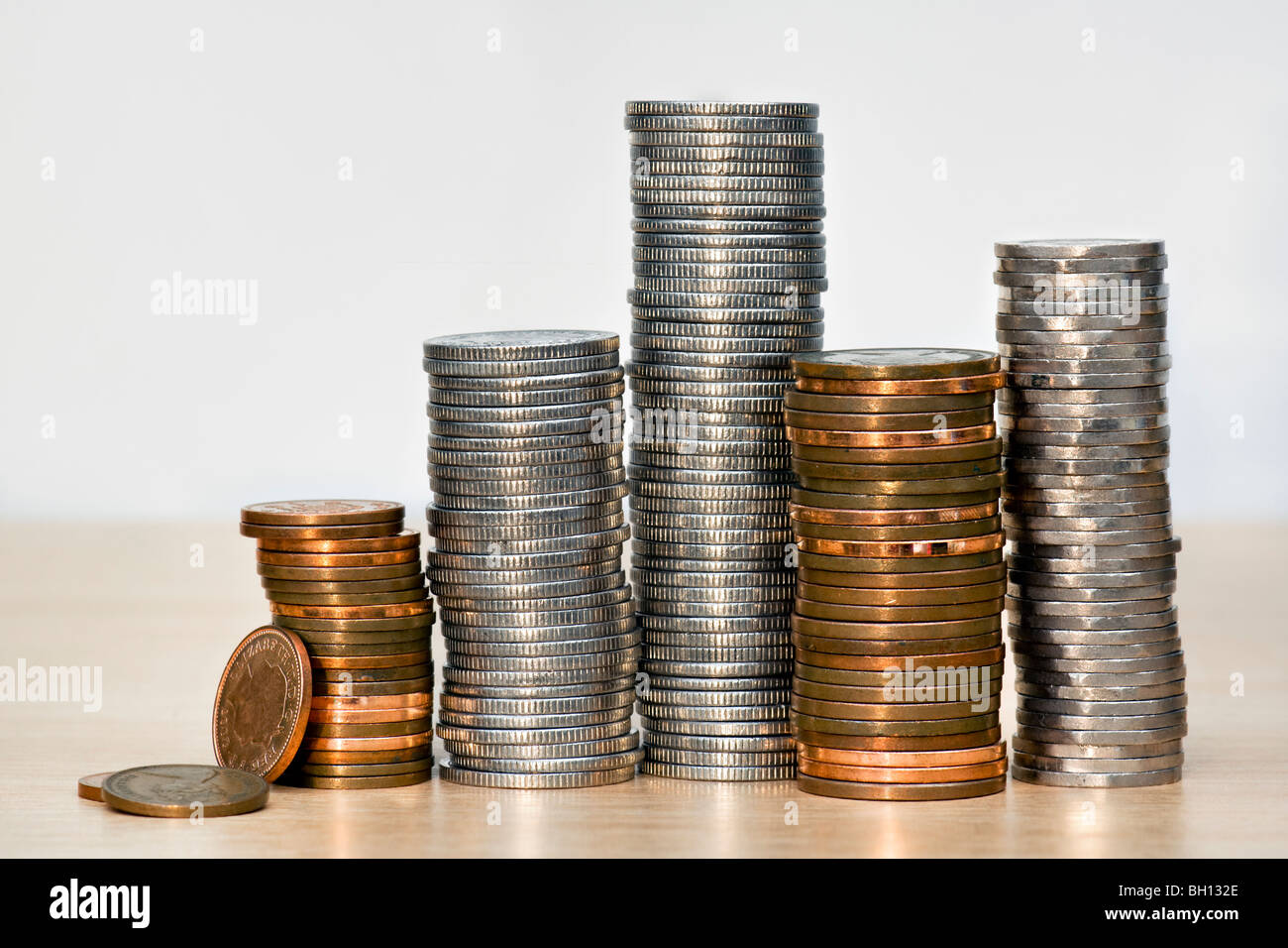 Stacks of English coins or sterling money in silver and coppers Stock Photo